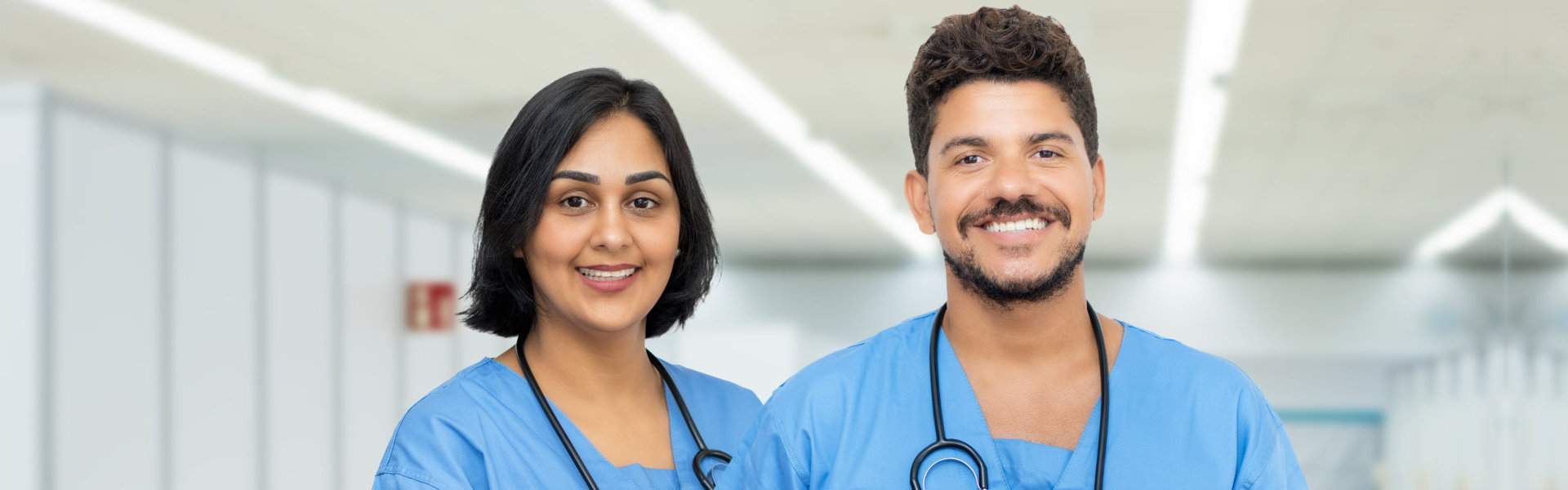 male and female nurse smiling at the camera